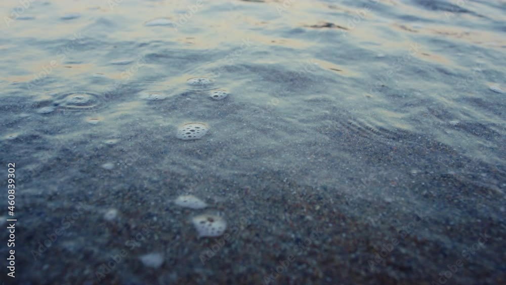Blue ocean water waves splashing sandy beach in slow motion. Abstract nature Blue ocean water waves splashing sandy beach in slow motion. Abstract nature
