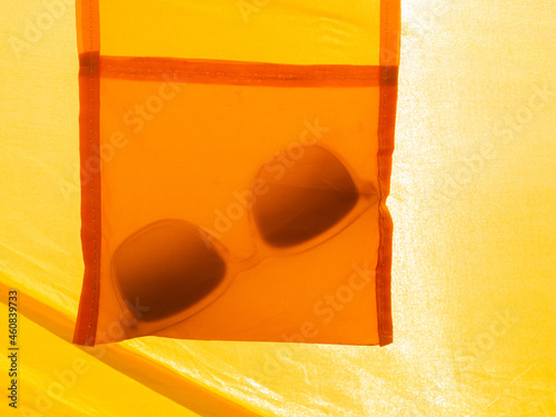 abstract orange and yellow image of sunglasses symbolizing the summer feeling