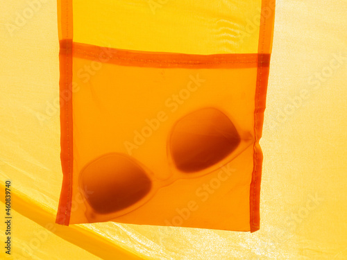 abstract orange and yellow image of sunglasses symbolizing the summer feeling