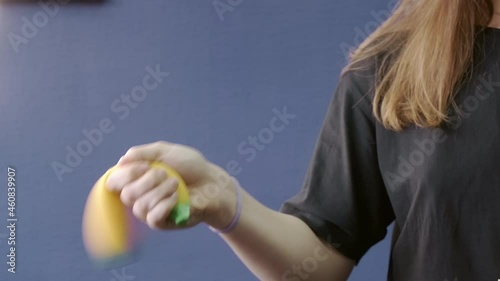 Video of woman shaking banana squishy toy in hand photo
