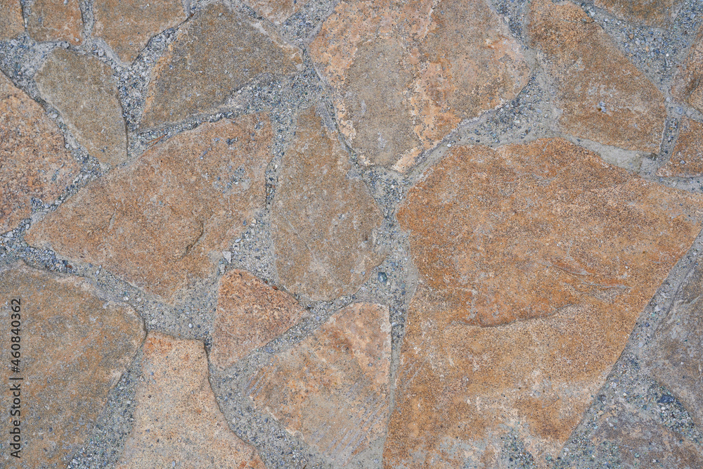 Fototapeta premium Orange old stone road surface. Seamless Texture. The texture of a stone road. High quality photo