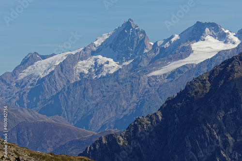 High snowy summits of Oisans mountain range seen from Chamrousse resort top