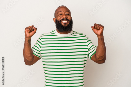 African american man with beard isolated on pink background celebrating a victory, passion and enthusiasm, happy expression.