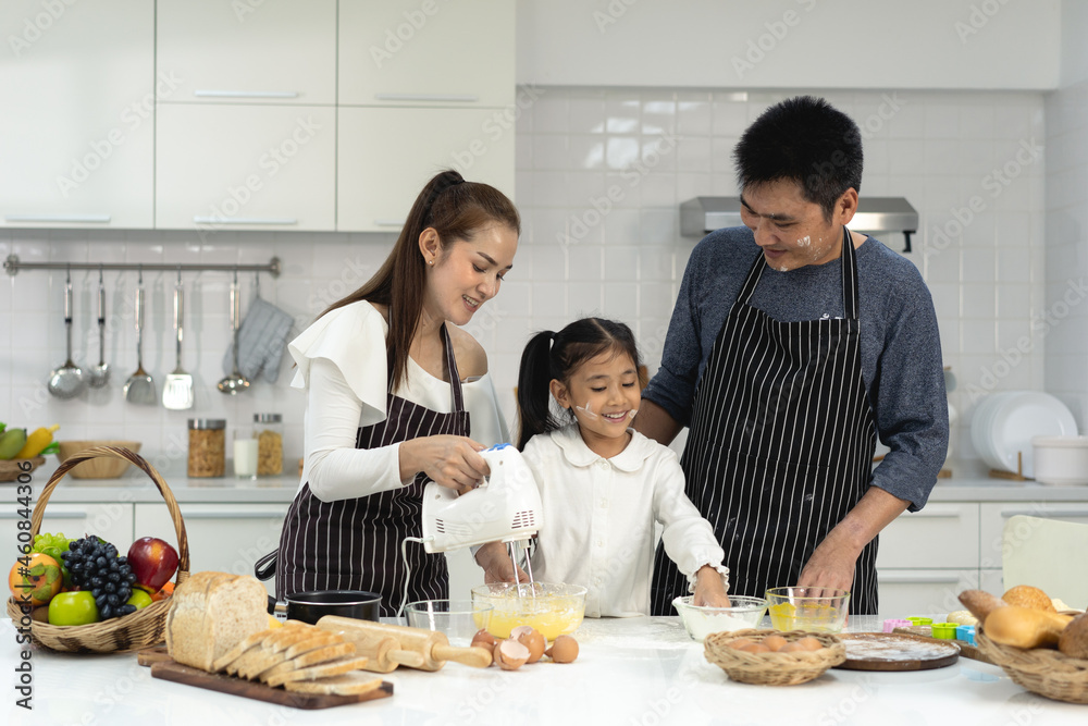 Happy asia family with daughter making dough preparing baking cookies, Daughter help parent preparing the bake Family concept Happy asia family with daughter making dough preparing baking cookies, Daughter help parent preparing the bake Family concept