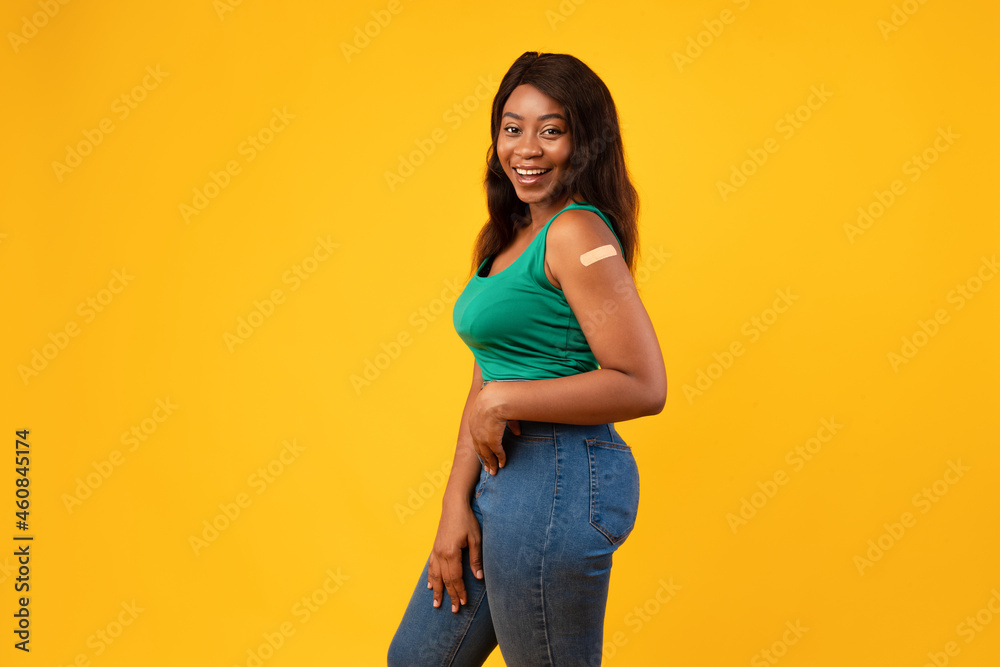 Vaccinated Black Young Woman Posing In Studio On Yellow Background Vaccinated Black Young Woman Posing In Studio On Yellow Background