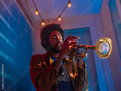 Young trumpeter performs at home
