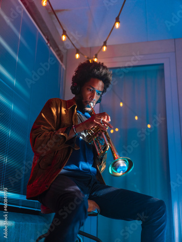 Young trumpeter performs at home