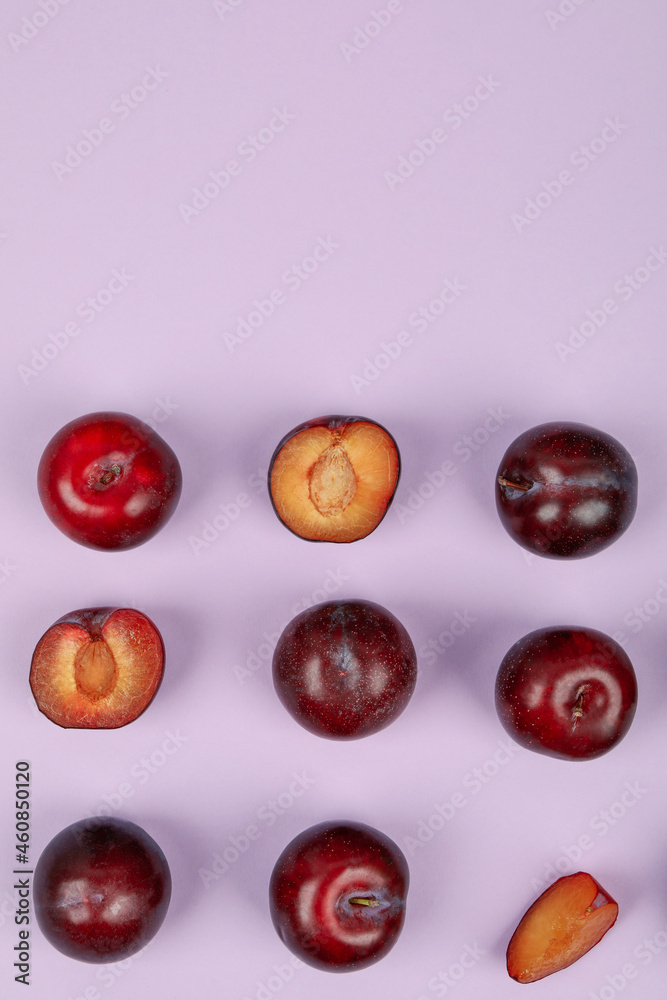 Flat lay composition with plums on purple background Flat lay composition with plums on purple background