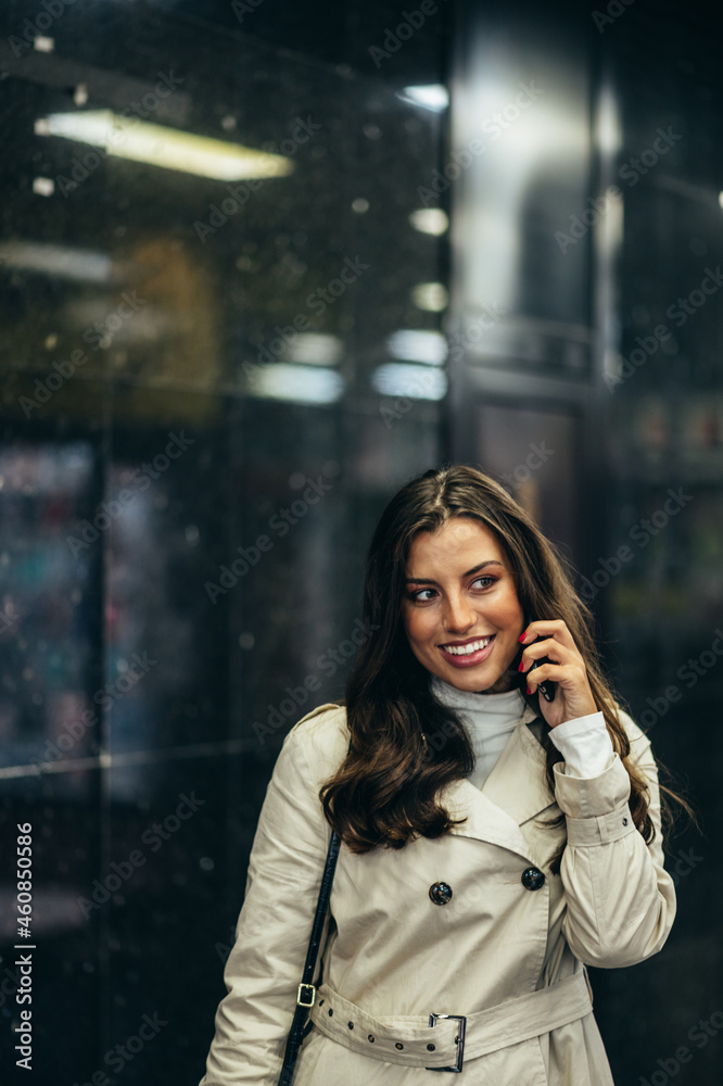 Beautiful young woman using a smartphone while in the subway