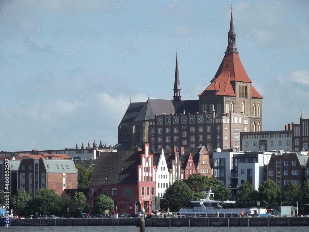 Obraz premium The Marienkirche in Rostock, Mecklenburg-Western Pomerania, Germany, seen across Warnow river