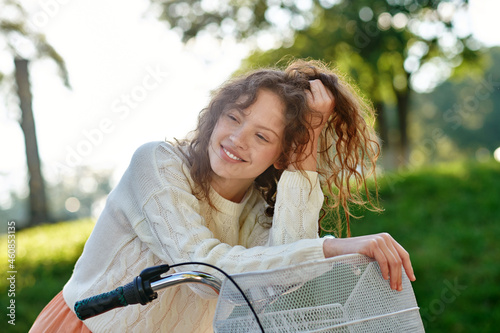 A cute fgirl on a bike feeling good and smiling photo
