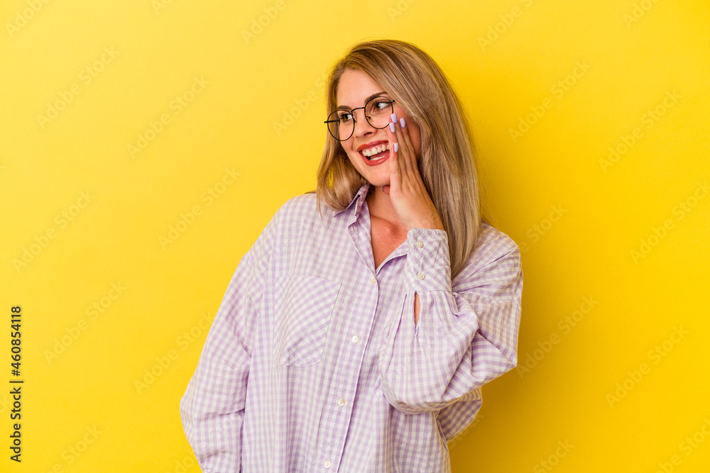 Young russian woman isolated on yellow background shouting excited to front. Young russian woman isolated on yellow background shouting excited to front.
