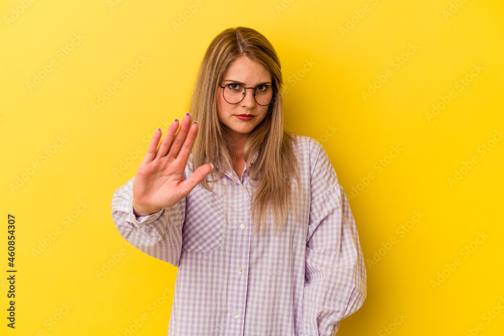 Young russian woman isolated on yellow background being shocked due to an imminent danger