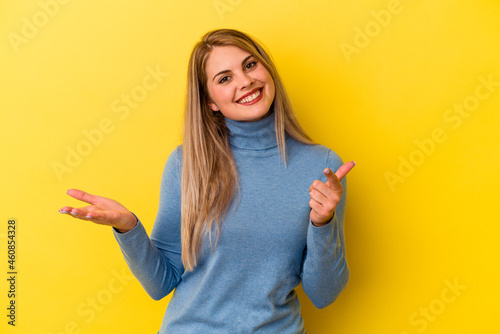 Young russian woman isolated on yellow background joyful laughing a lot. Happiness concept.