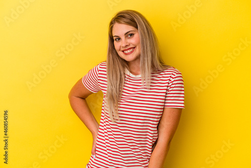 Young russian woman isolated on yellow background happy, smiling and cheerful.