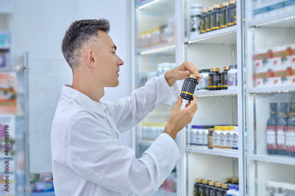 Profile of man in white coat considering medication Profile of man in white coat considering medication