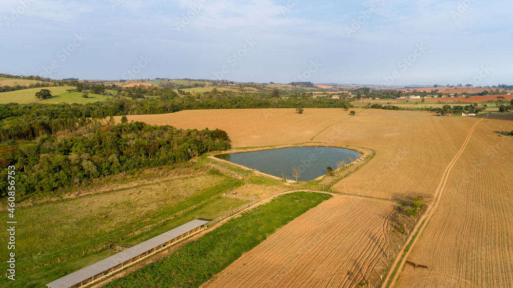 Aerial view of a productive farm with a lake. Fertile land for planting. In São Paulo, Brazil