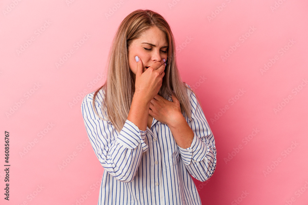 Young russian woman isolated on pink background suffers pain in throat due a virus or infection. Young russian woman isolated on pink background suffers pain in throat due a virus or infection.