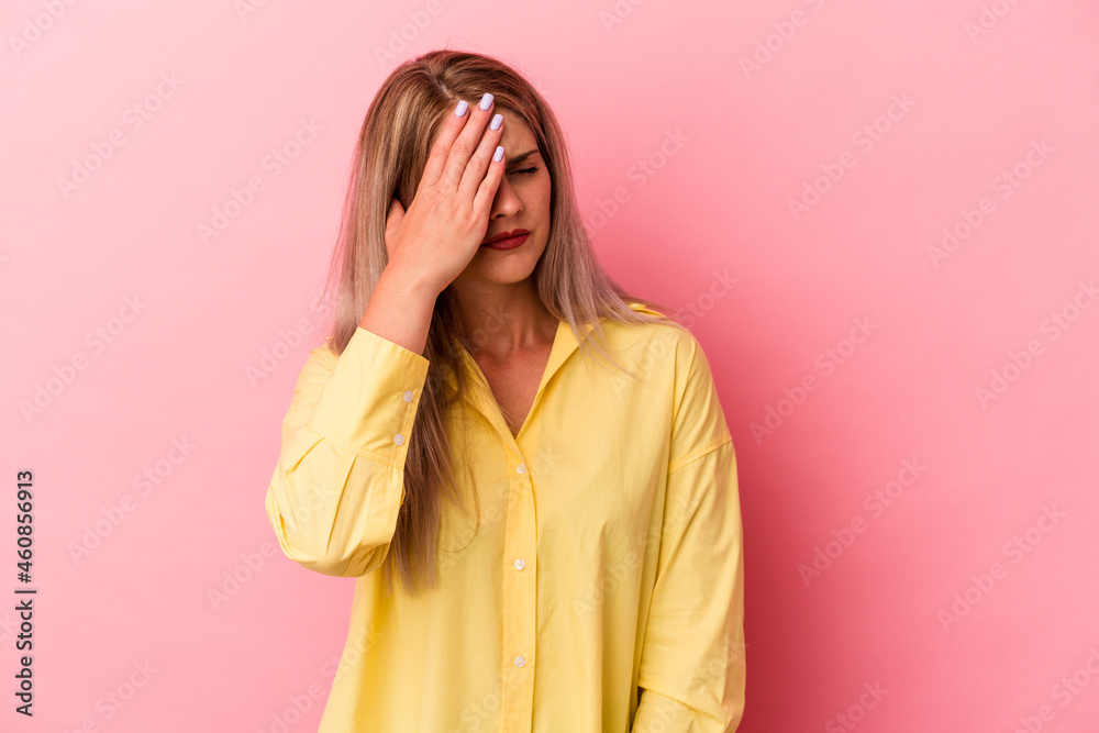 Young russian woman isolated on pink background having a head ache, touching front of the face. Young russian woman isolated on pink background having a head ache, touching front of the face.