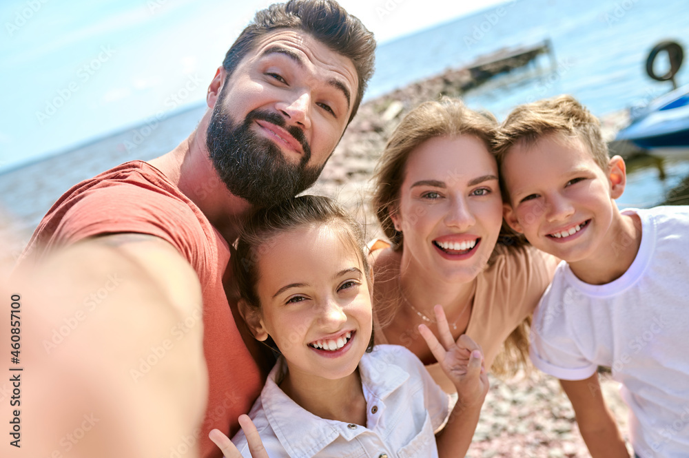 A picture of happy smiling family having fun on a beach