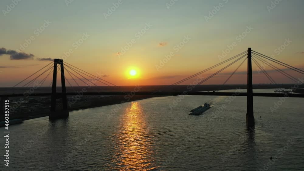 Hale Boggs Memorial Bridge and Push boat and barge at sunset