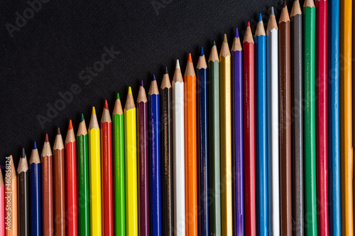 colored pencils on a black background