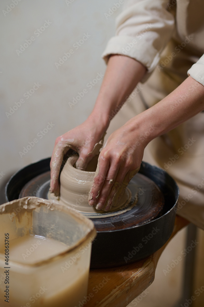Close up of human hands on a pottery wheel Close up of human hands on a pottery wheel
