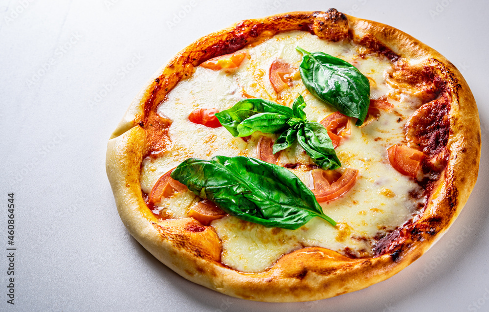 Pizza with Mozzarella cheese, Tomatoes, pepper, Spices. Italian pizza. Pizza Margherita or Margarita on grey background