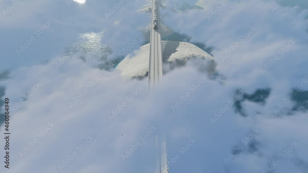 Train in the clouds above the mountains, wintertime, top view Train in the clouds above the mountains, wintertime, top view