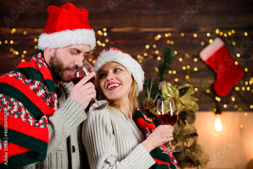 Idyllic date. Man woman santa claus hats cheerful celebrating new year. Romantic ideas celebration. Merry christmas. Celebrating together. Celebrating winter holiday. Couple in love enjoy red wine