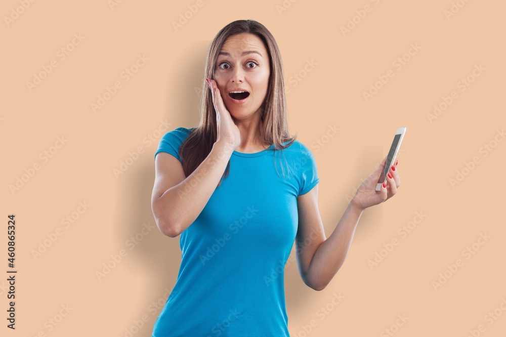 Dreamy young pretty woman holds mobile phone Dreamy young pretty woman holds mobile phone