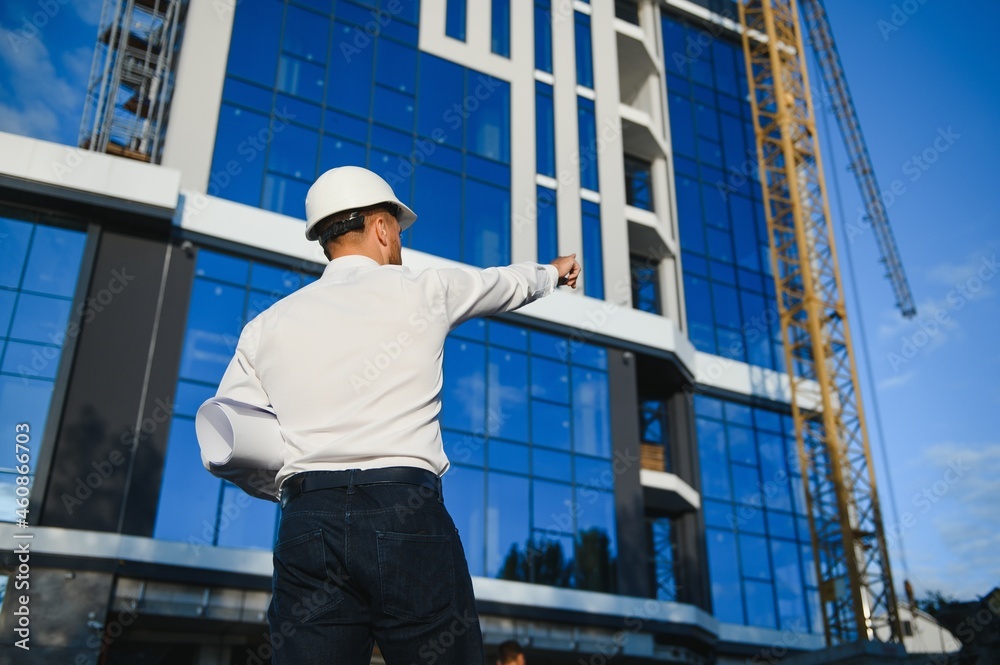 Industrial theme: constructor standing at a site area. Industrial theme: constructor standing at a site area.