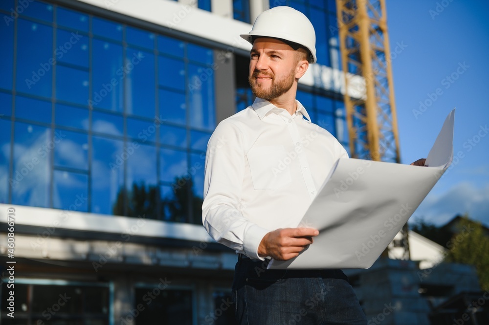 Industrial theme: constructor standing at a site area. Industrial theme: constructor standing at a site area.