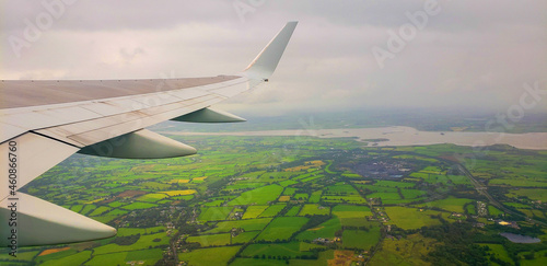 airplane wing over pastures