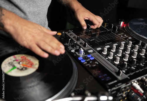 Hip hop dj scratching vinyl records on turntables. Disc jockey mixing music on concert with retro turn table player and sound mixer devices