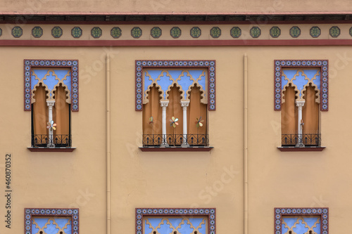 Detailed view of the exterior facade of a Moorish-style building, Arabic architecture with decorative elements, arabic multifoil arches and decorative tiles, in Córdoba city photo