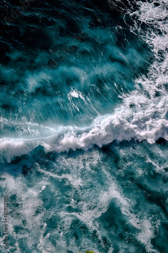 Aerial view to seething waves with foam. Waves of the sea meet each other during high tide and low tide