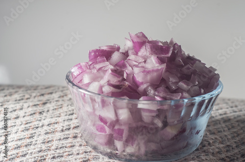 chopped red onion in a bowl ,copy space left and white background