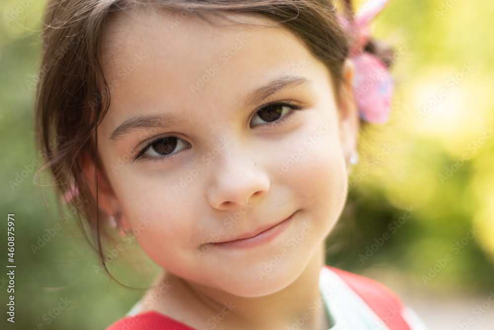 Close-up portrait of little smiling cute white girl on blurred background Close-up portrait of little smiling cute white girl on blurred background
