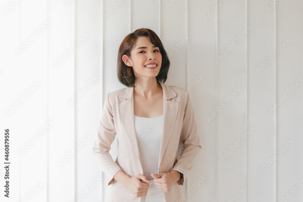 Confident Asian working woman in beige blazer isolated on white background. Confident Asian working woman in beige blazer isolated on white background.