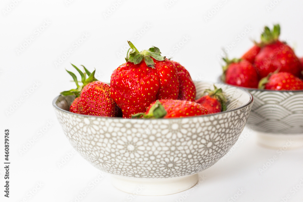 Strawberries in round plates, arranged on a white background. Strawberries in round plates, arranged on a white background.