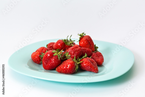 Delicious red strawberries  isolated on a plate. Background texture.