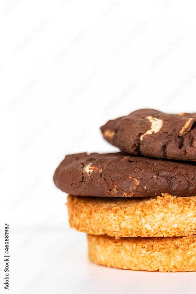 Coconut and chocolate cookies on a white background together Coconut and chocolate cookies on a white background together