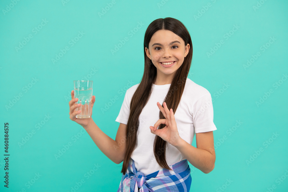 happy teen girl drink glass of water to keep daily water balance show ok gesture, drink water. happy teen girl drink glass of water to keep daily water balance show ok gesture, drink water.