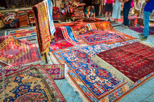 Traditional Georgian Carpets with typical geometrical patterns in the street shop, Tbilisi, Georgia © Olena Zn