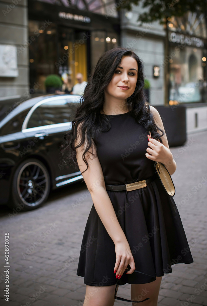 Fototapeta premium European Woman with dark hair and pale skin, in vintage style at city, fashionable outdoor portrait