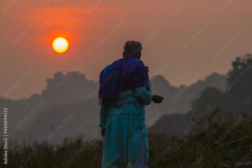 Rear view of a elder man looking at sunrise