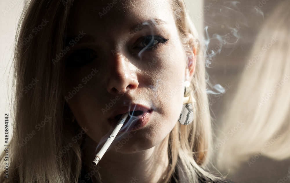 Fototapeta premium Young Woman Smoking Cigarette