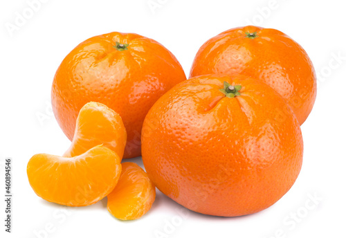 Sweet ripe tangerines and mandarin slices isolated on white background.