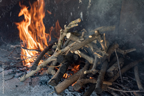 Firewood burning in a fireplace for a barbecue.